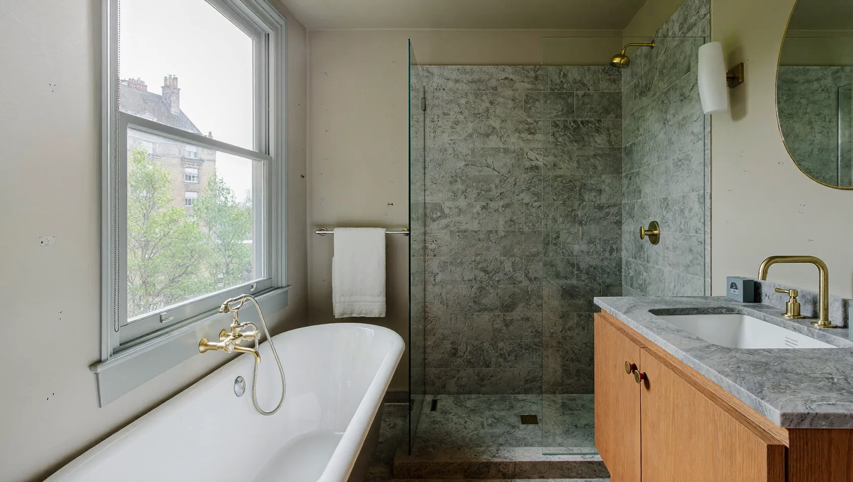 Bathroom with a freestanding bath, brass taps and a walk-in shower