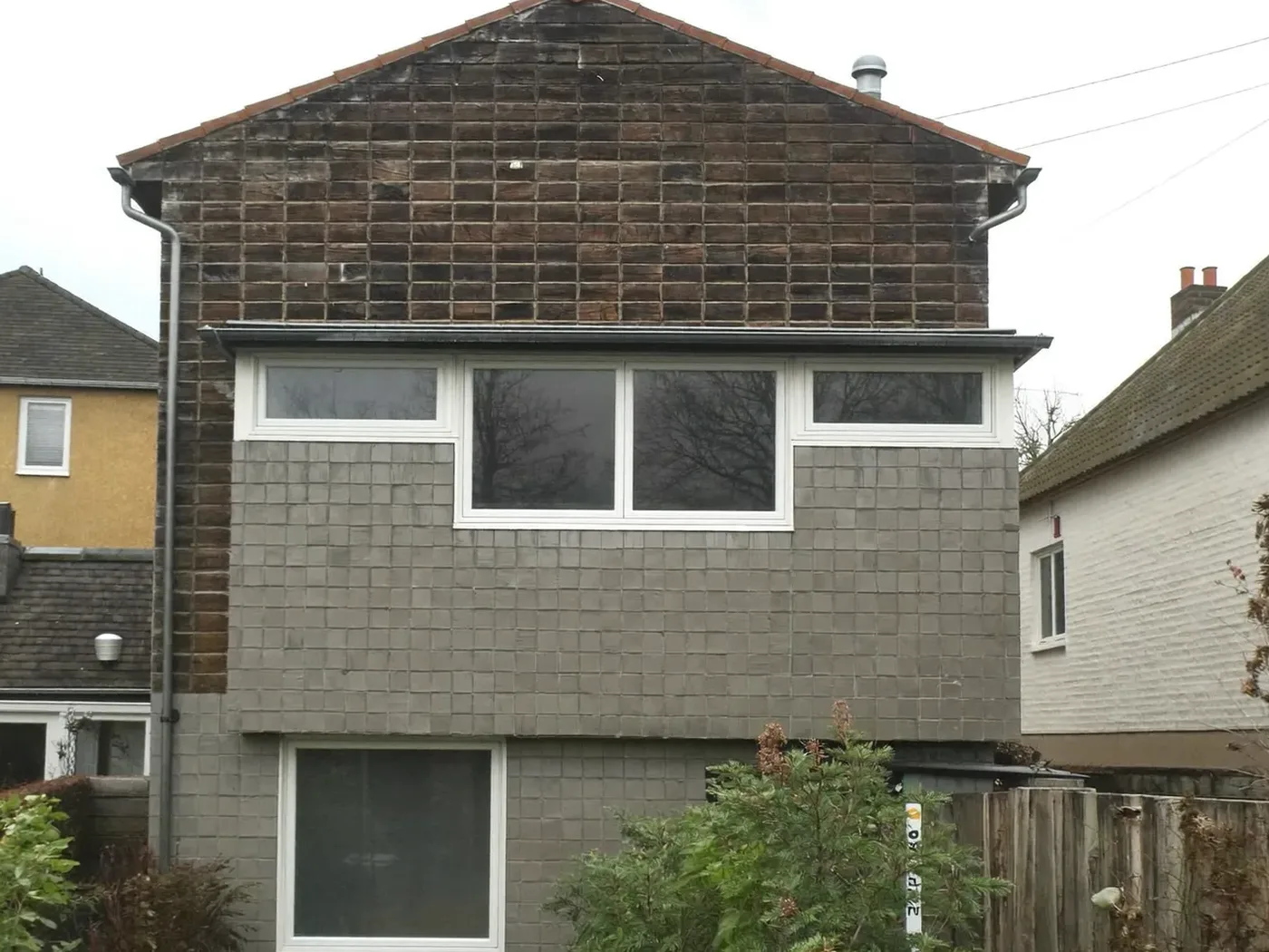 Amersham: grey-clad box dormer loft conversion on the rear roof of a house with white windows