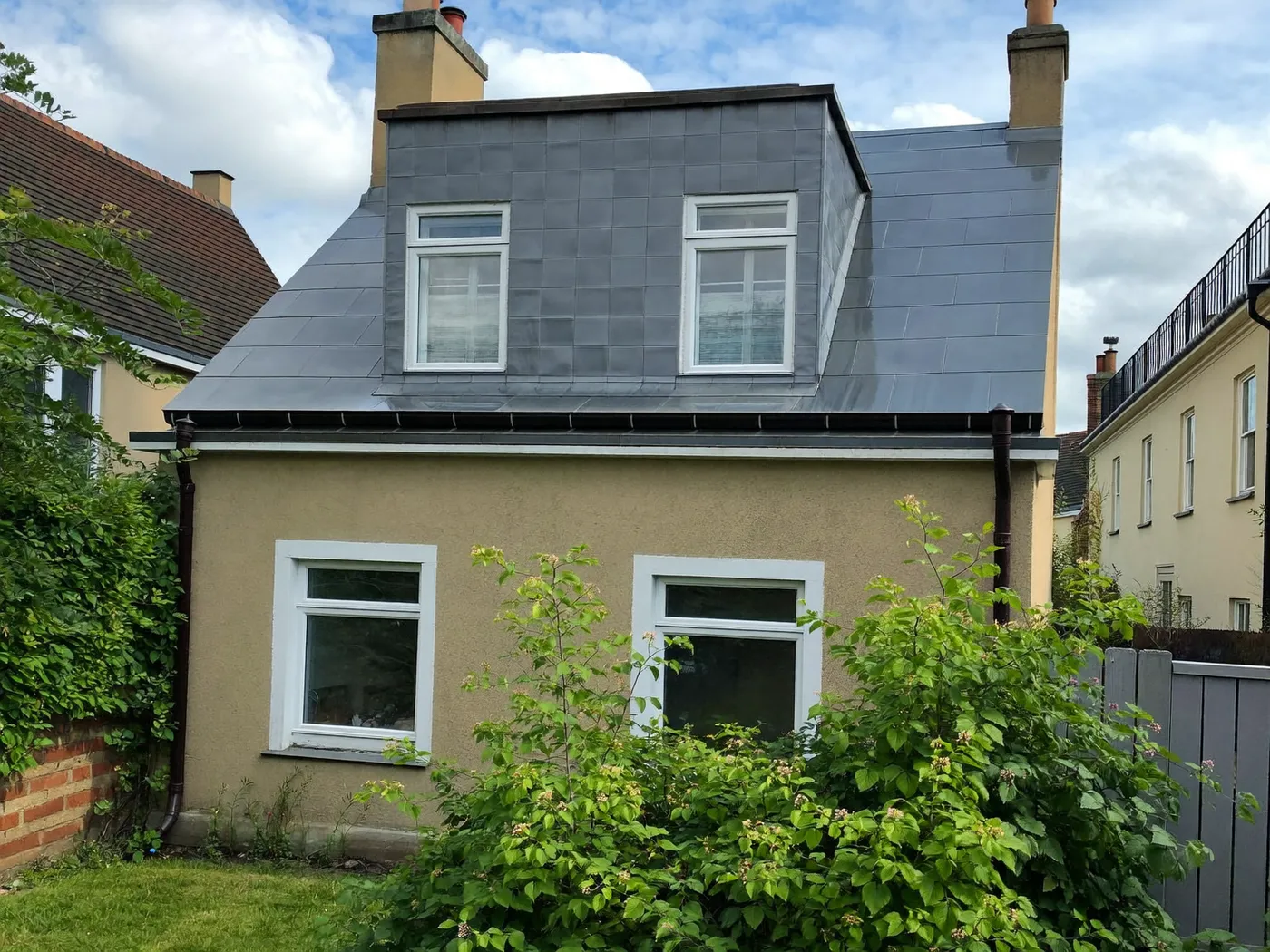 Barking & Dagenham: grey-clad box dormer loft conversion on the rear roof of a house with white windows