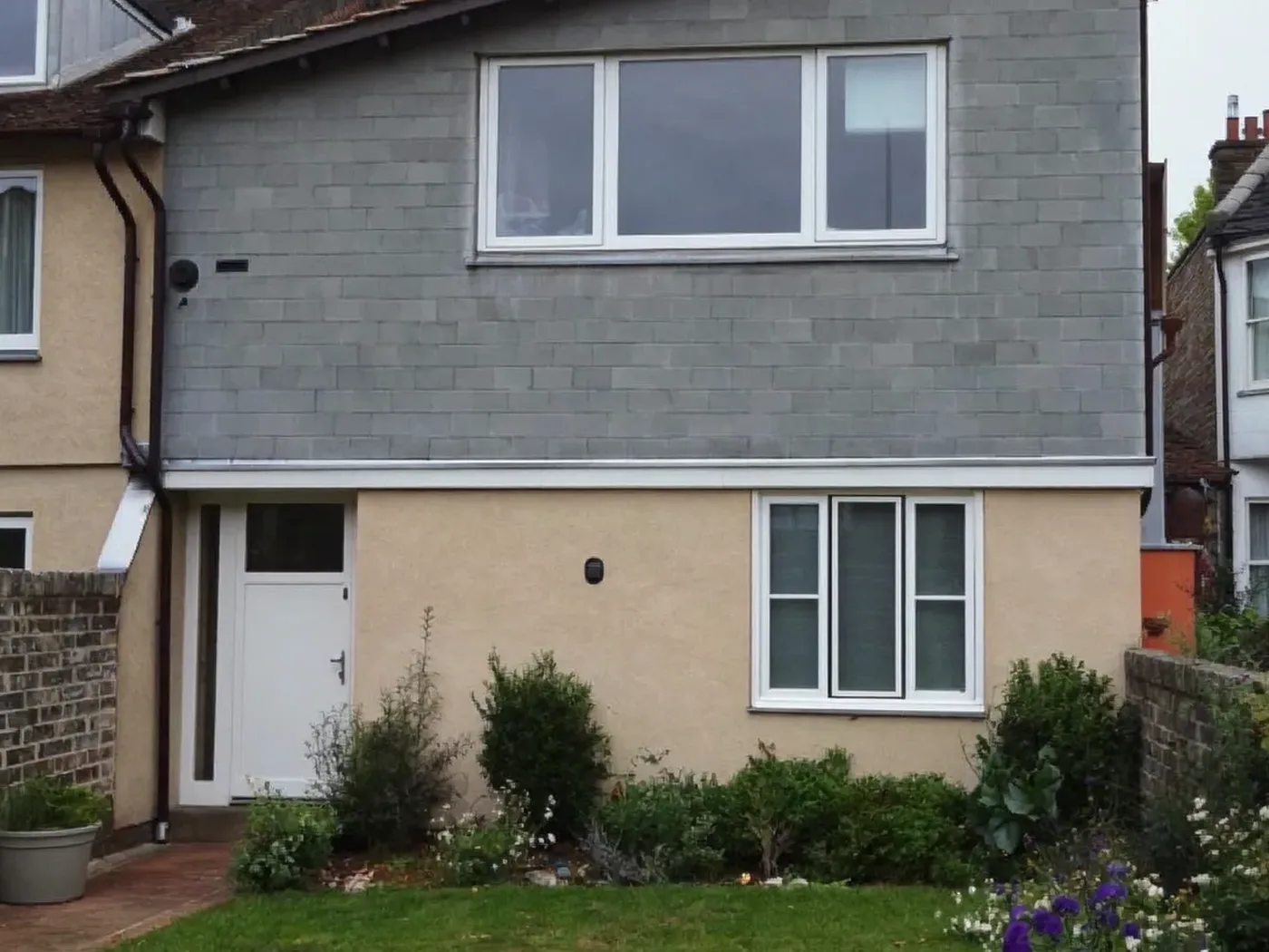 Borehamwood: grey-clad box dormer loft conversion on the rear roof of a house with white windows