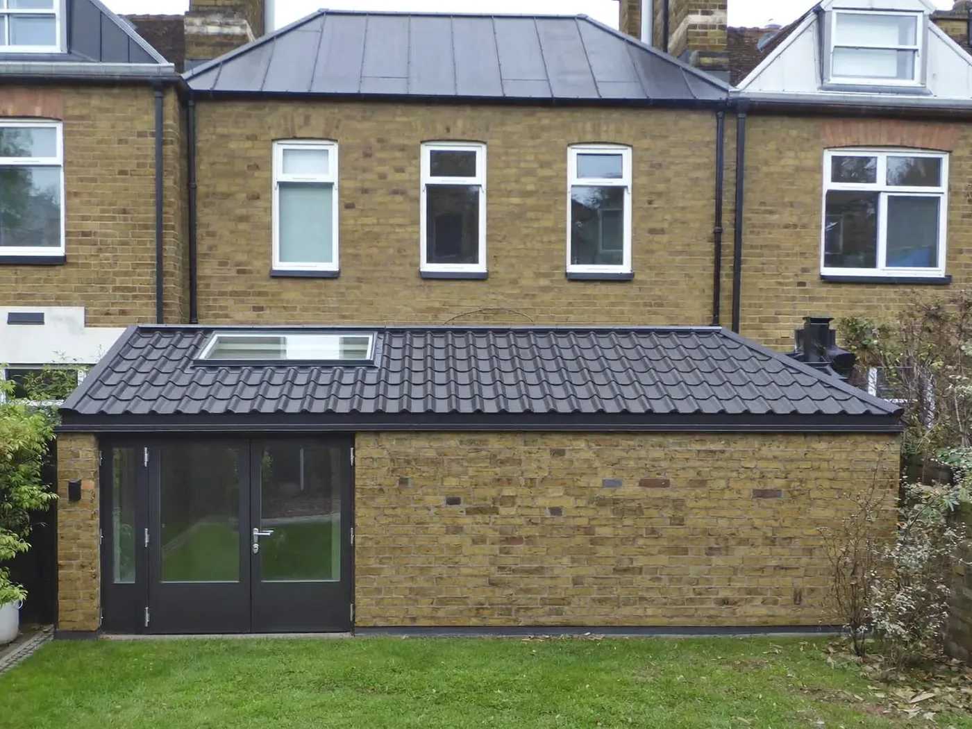 Brent: brick side-return extension at the back of a terraced house with white French doors