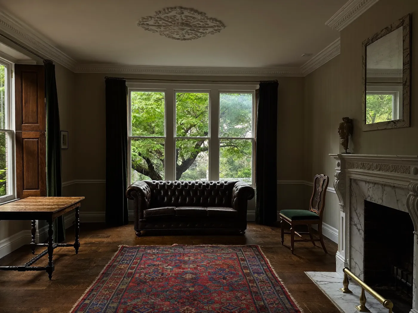 Camden: restored Victorian reception room with a fireplace, cornicing and sash windows