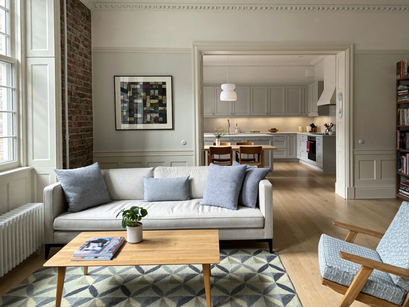 Open-plan living area with a pale sofa, oak coffee table, blue armchair and tall windows