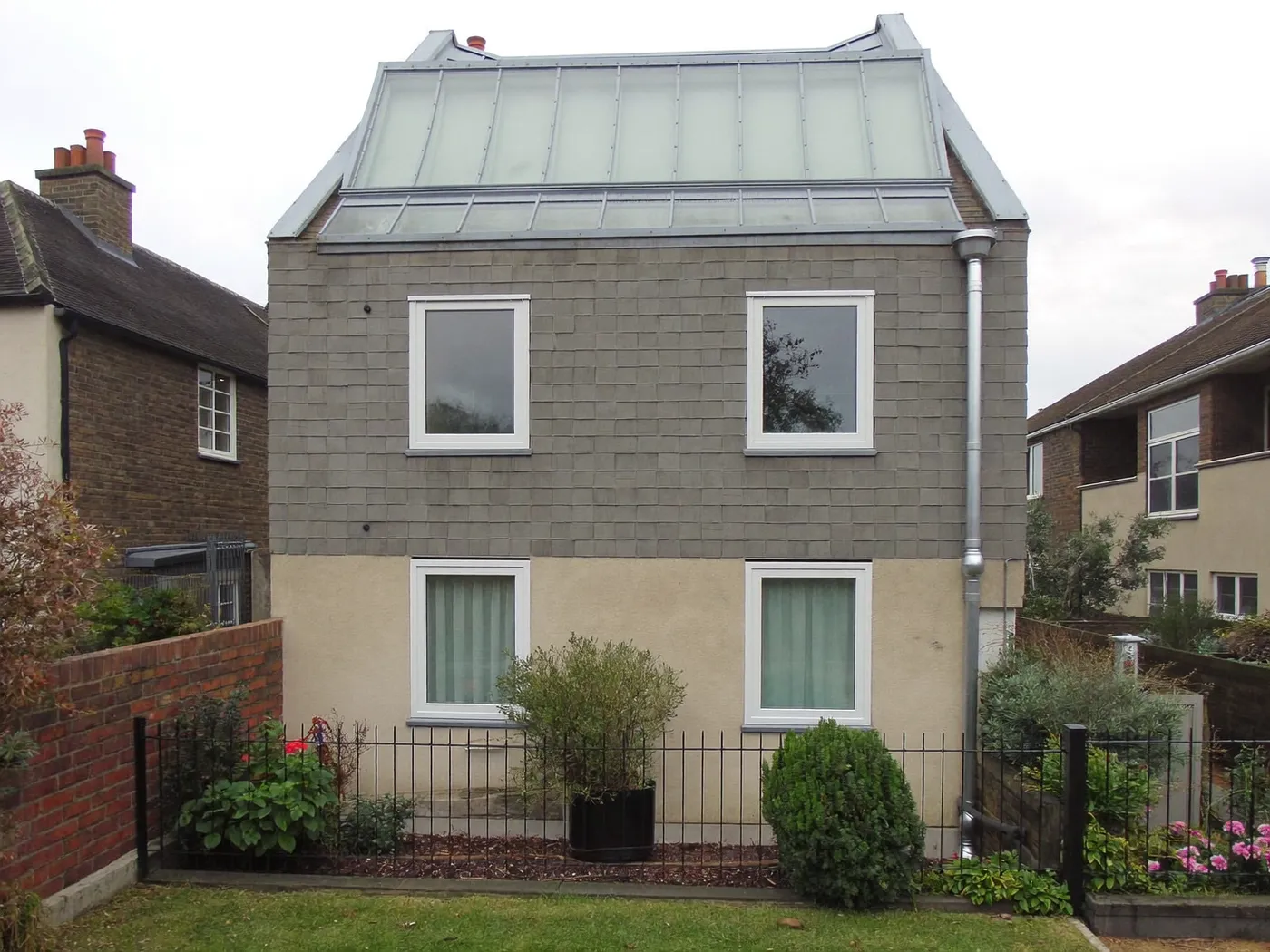 Ealing: grey-clad box dormer loft conversion on the rear roof of a house with white windows
