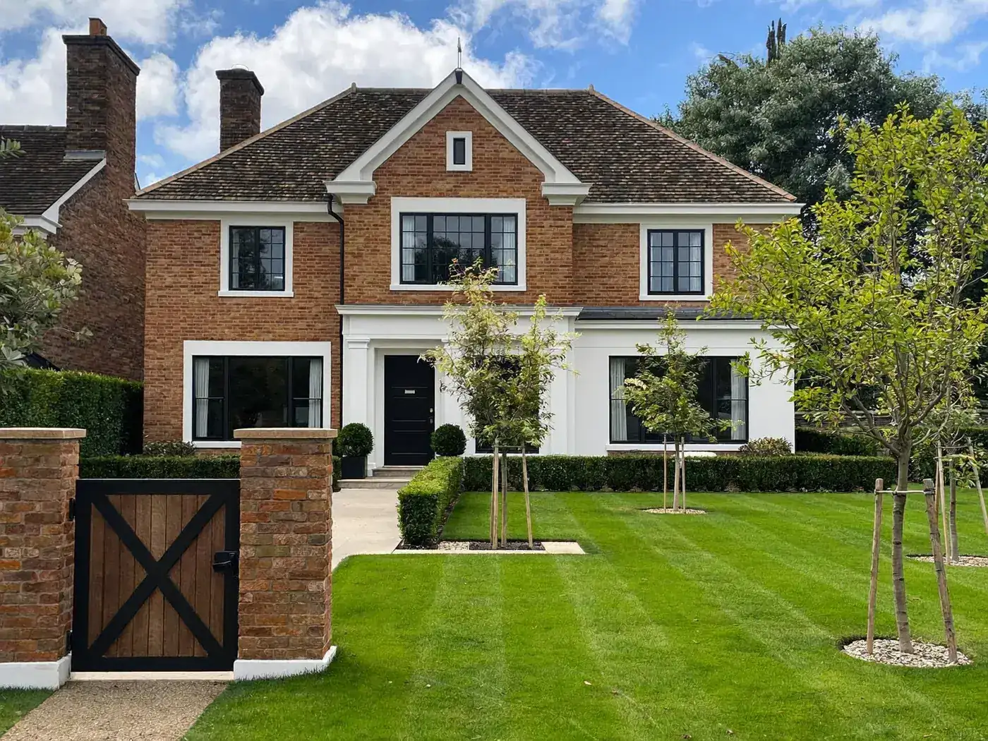 Elmbridge: newly built brick detached house with a tiled roof on a large plot