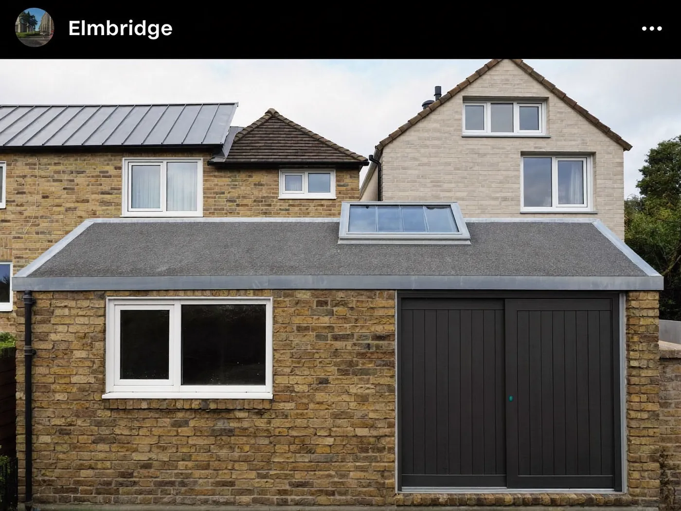 Elmbridge: L-shaped brick extension wrapping around the back and side of a house with dark sliding doors