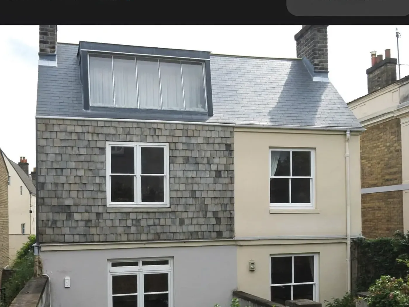 Greenwich: grey-clad box dormer loft conversion on the rear roof of a house with white windows