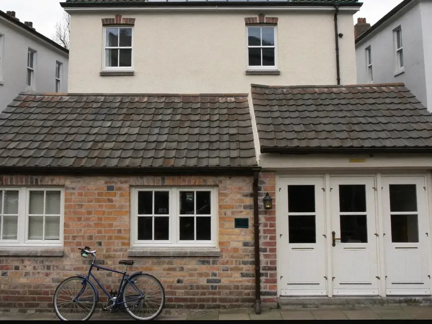 Hammersmith & Fulham: brick side-return extension at the back of a terraced house with white French doors