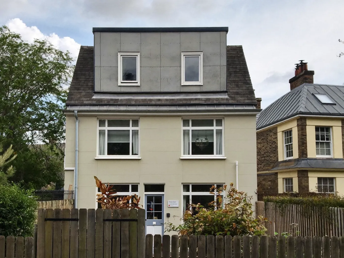 Hammersmith & Fulham: grey-clad box dormer loft conversion on the rear roof of a house with white windows