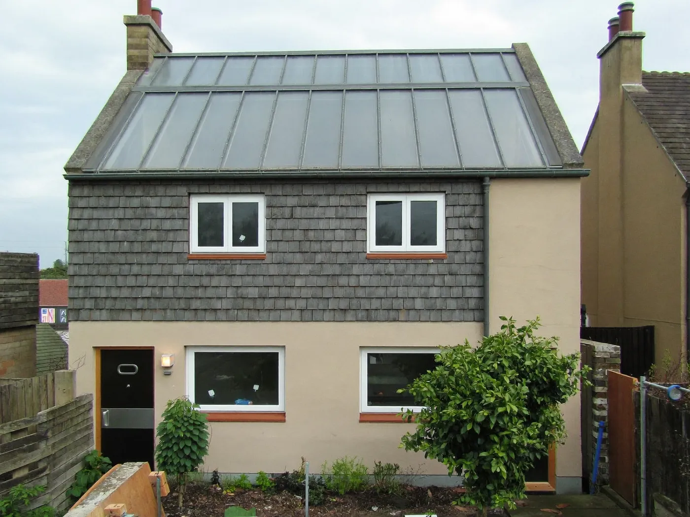 Hertfordshire: grey-clad box dormer loft conversion on the rear roof of a house with white windows