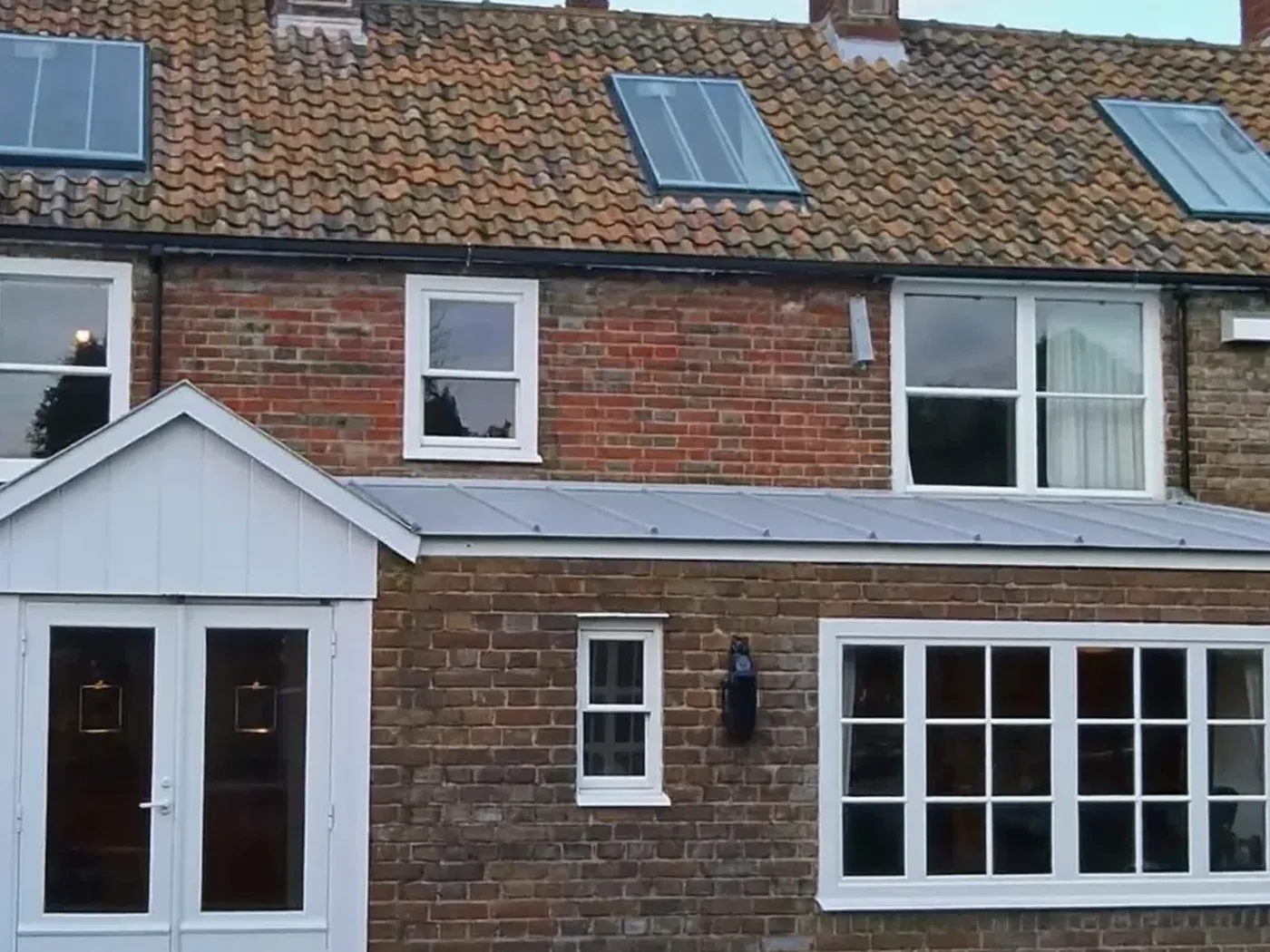Islington: brick side-return extension at the back of a terraced house with white French doors