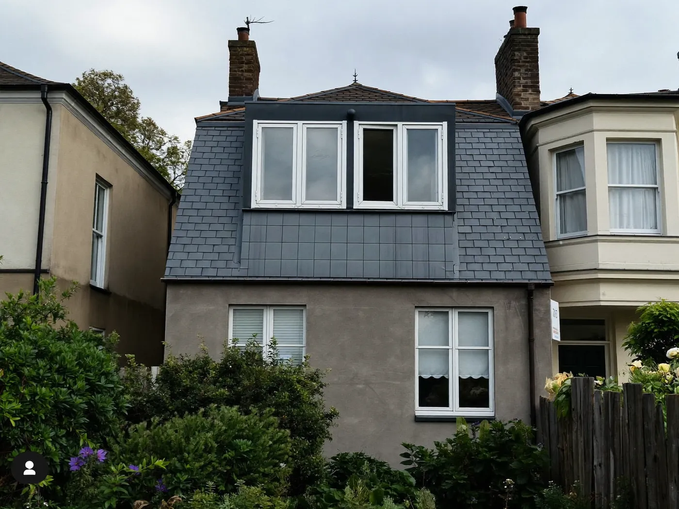 Islington: grey-clad box dormer loft conversion on the rear roof of a house with white windows