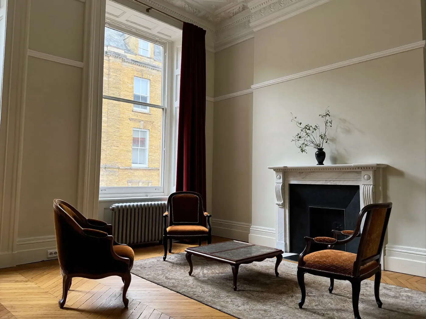 Kensington & Chelsea: restored Victorian reception room with a fireplace, cornicing and sash windows