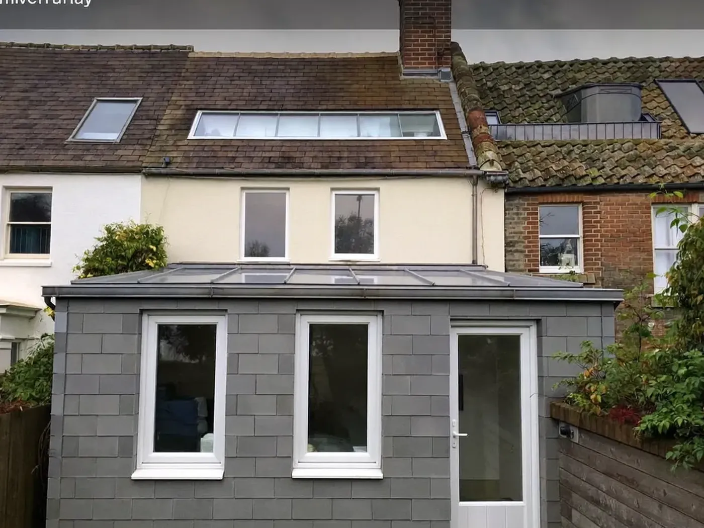 Lewisham: grey-clad box dormer loft conversion on the rear roof of a house with white windows