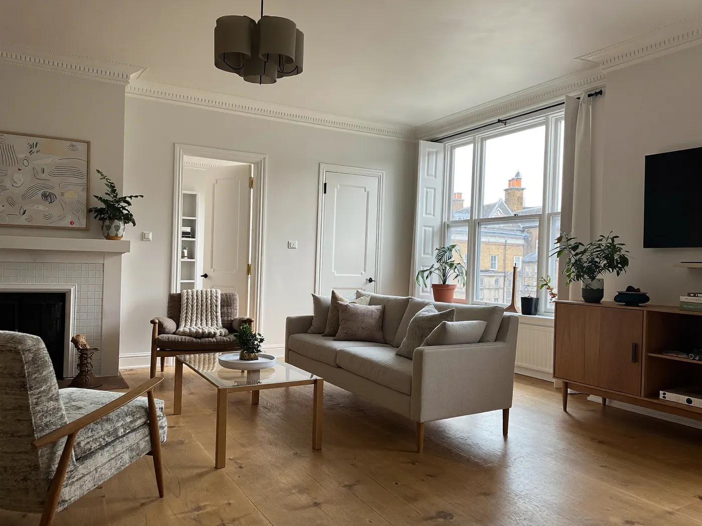 Lewisham: renovated living room with painted walls and wooden flooring