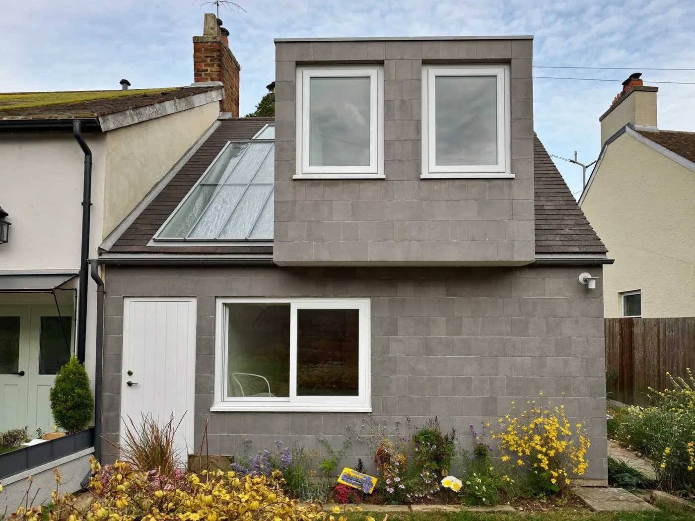 Potters Bar: grey-clad box dormer loft conversion on the rear roof of a house with white windows