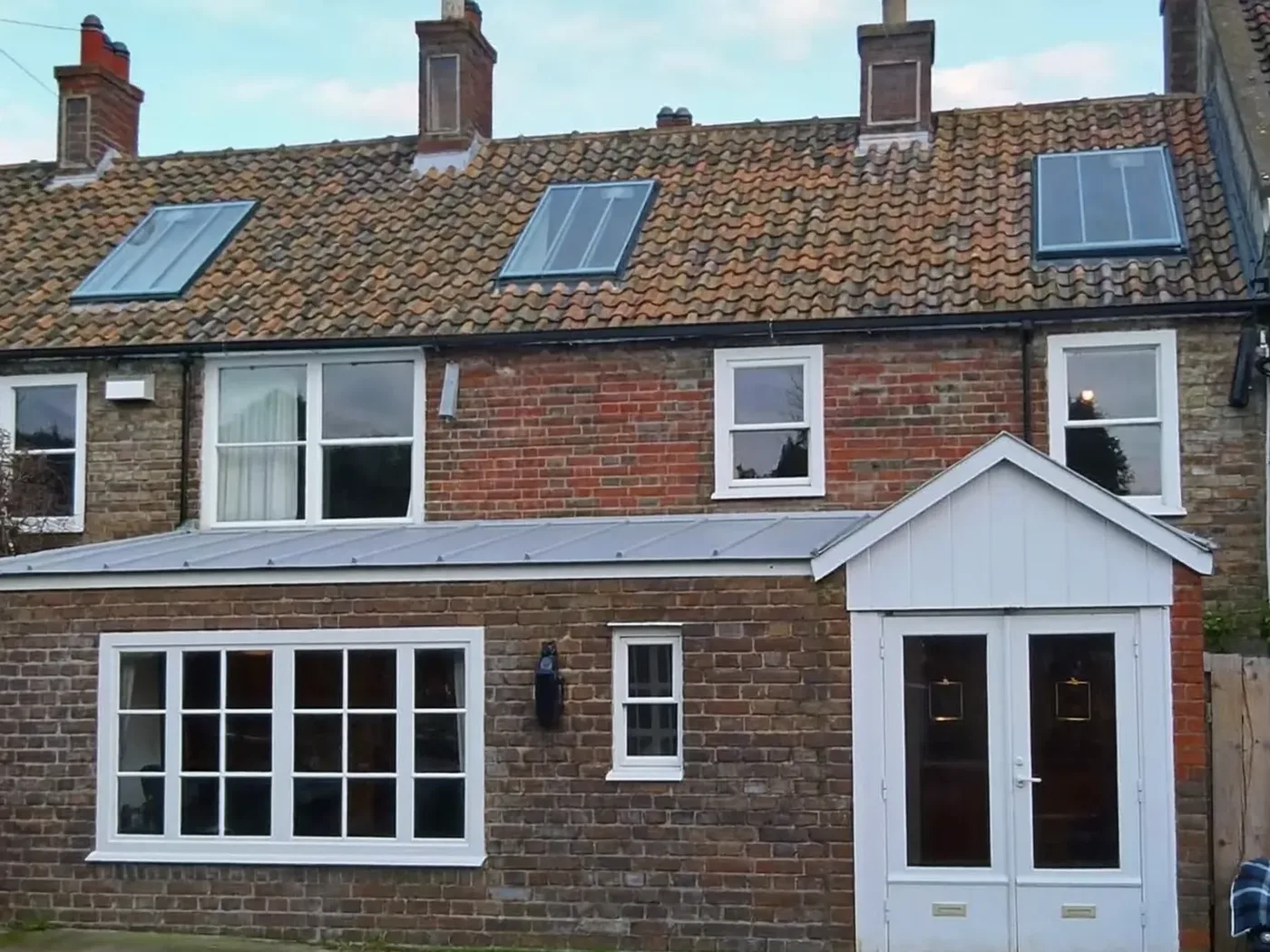 Southwark: brick side-return extension at the back of a terraced house with white French doors