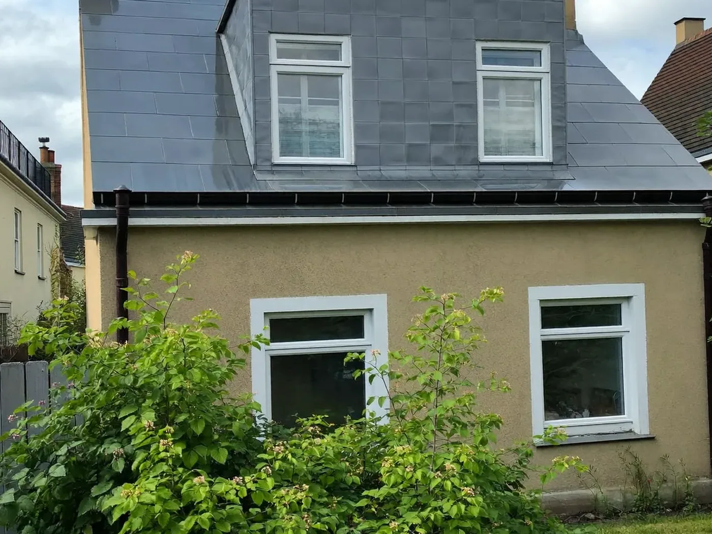Wandsworth: grey-clad box dormer loft conversion on the rear roof of a house with white windows