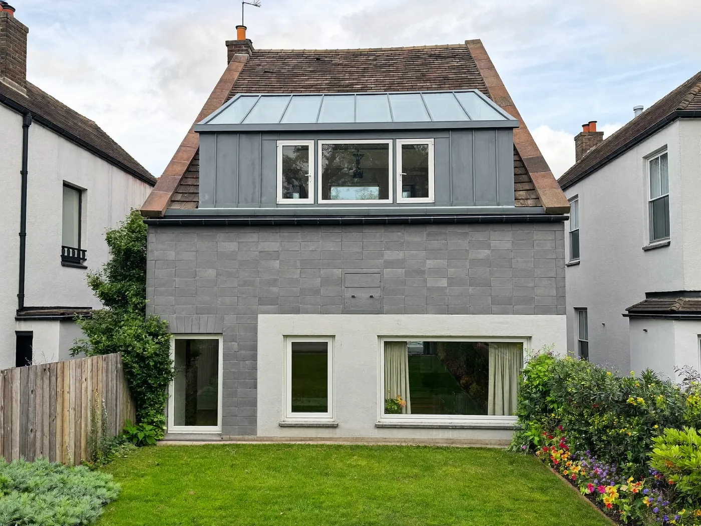 Watford: grey-clad box dormer loft conversion on the rear roof of a house with white windows